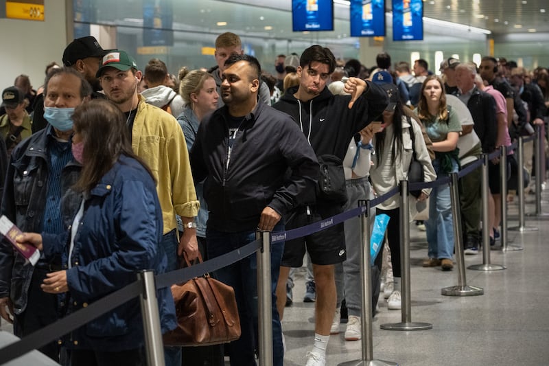 One traveller shows his disappointment while waiting in a long queue to pass through a security check in June. Getty Images