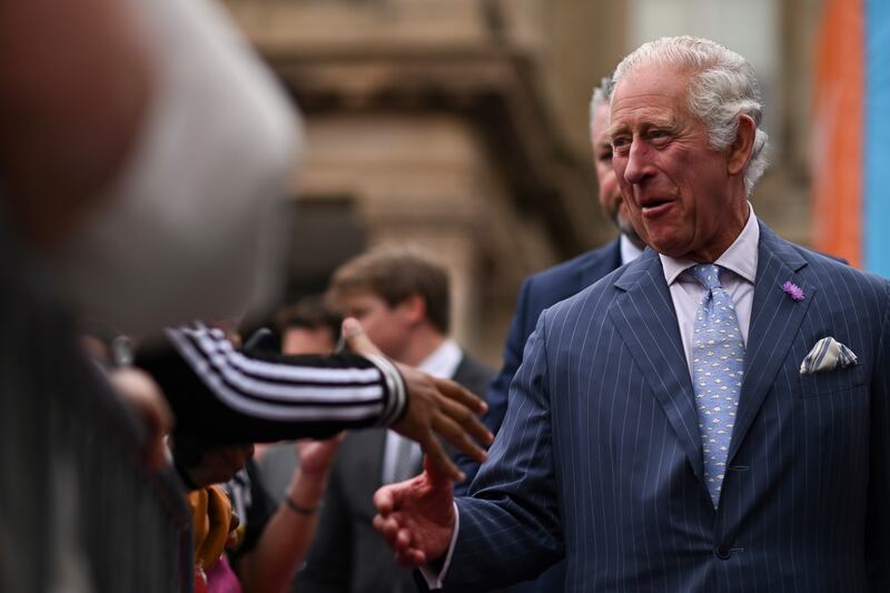 The Prince of Wales greets people during a visit to the Festival Site at Victoria Square. PA