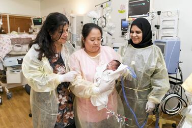 Dr Leanne Bricker, left, with colleagues at the Corniche Hospital. Abu Dhabi's largest maternity hospital delivers 6,000 babies a year. Reem Mohammed / The National