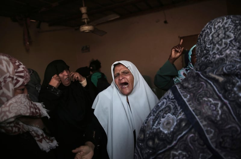Relatives of 25-year-old Ahmed Arafa, who was shot and killed Tuesday by Israeli troops during the ongoing protest along the Gaza Strip border with Israel, mourn during his funeral in town of Deir el-Balah, central Gaza Strip, Wednesday, April 4, 2018. (AP Photo/Khalil Hamra)