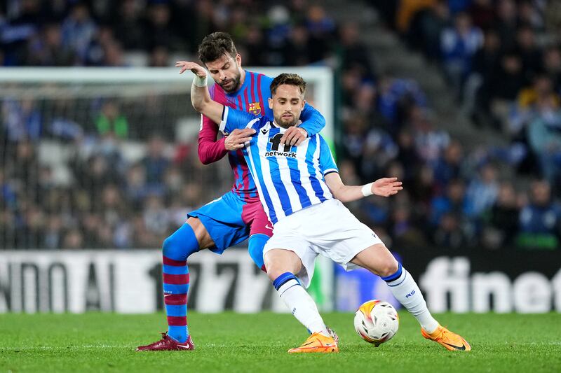 Adnan Januzaj of Real Sociedad is challenged by Gerard Pique of Barcelon. Getty Images