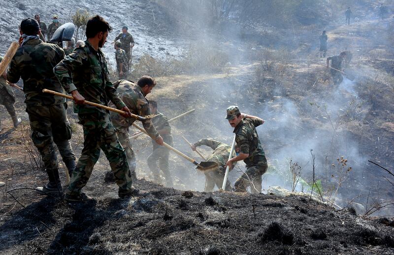 Soldiers were called in to help extinguish blazes in Latakia in October, 2020. Reuters