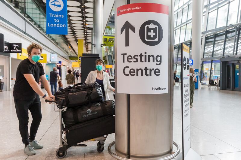 Passengers arrive at London's Heathrow Airport. The UK has added the UAE to its amber travel list.