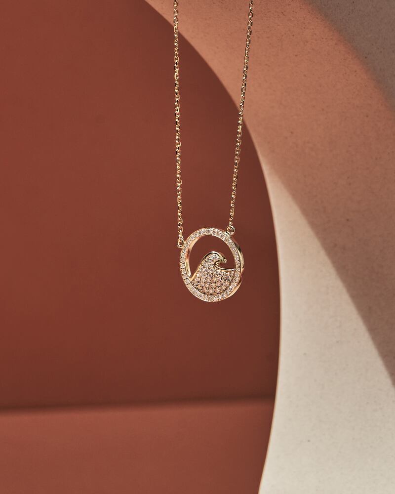 Wave diamond necklace with lab-grown diamonds (approximately 0.40 carats) fixed within a circular pendant and set on an 18k solid gold adjustable chain; Dh4,325, from Fyne Diamonds.