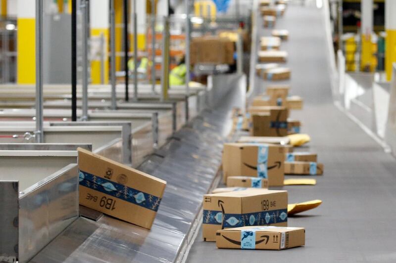 FILE - In this Dec. 17, 2019, file photo, Amazon packages move along a conveyor at an Amazon warehouse facility in Goodyear, Ariz. Amazonâ€™s pandemic boom isnâ€™t showing signs of slowing down. The company said Thursday, April 29, 2021, that its first-quarter profit more than tripled from a year ago, fueled by the growth of online shopping. It also posted revenue of more than $100 billion, the second quarter in row that the company has passed that milestone. (AP Photo/Ross D. Franklin, File)