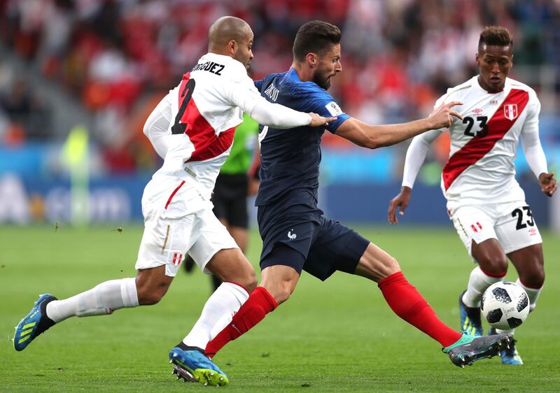 Olivier Giroud of France is challenged by Alberto Rodriguez of Peru. Catherine Ivill / Getty Images