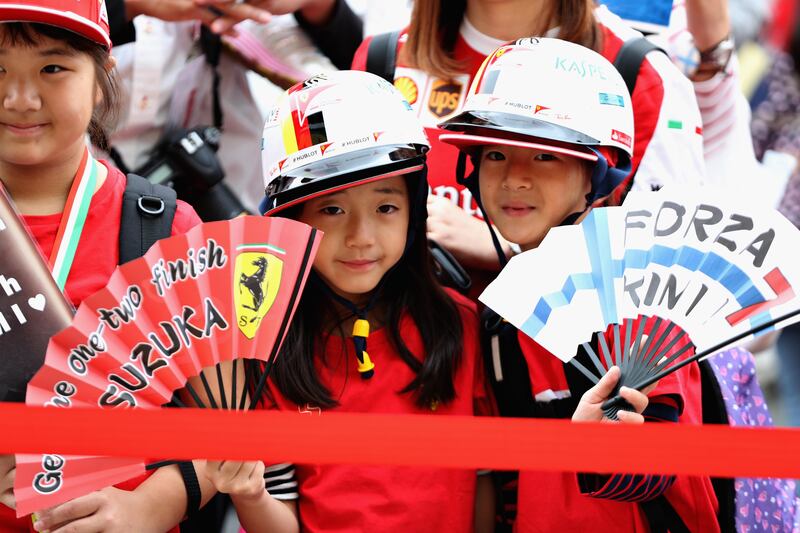 A pair of young Ferrari fans during previews ahead of the Formula One Grand Prix of Japan at Suzuka Circuit. Mark Thompson / Getty Images.