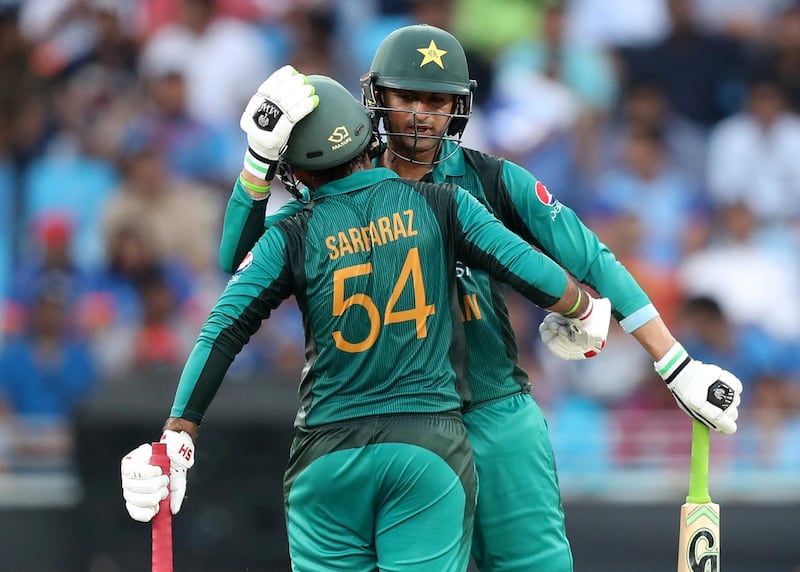 Dubai, United Arab Emirates - September 23, 2018: Pakistan's Shoaib Malik makes 50 and is congratulated by his captain Sarfraz Ahmed (L) during the game between India and Pakistan in the Asia cup. Sunday, September 23rd, 2018 at Sports City, Dubai. Chris Whiteoak / The National