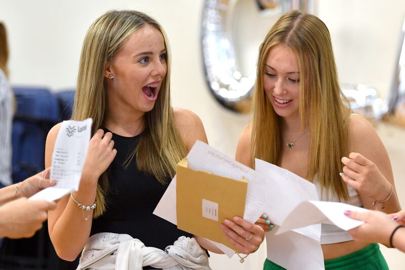Megan Brough and Isabella Chisnall react as students receive their GCSE results at Longdendale High School in 2022 in Hyde, Greater Manchester. Getty Images