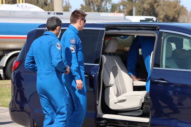 The crew board a vehicle to go to their quarantine quarters