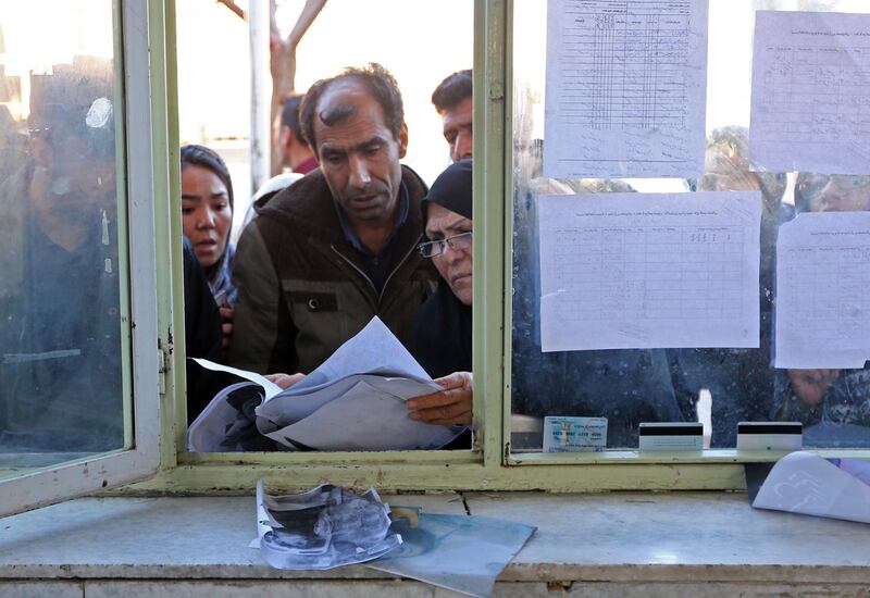 Relatives check the lists of victims at the information office of a hostpial in the southeastern Iranian city of Kerman following a stampede that broke out at the funeral of Revolutionary Guards commander Qasem Soleimani on January 7, 2020. The crush that left 40 people dead came as Iran prepared to bury the top Iranian general, a hugely popular figure in the Islamic republic who was killed last week in a US drone strike near Baghdad international airport. AFP correspondents in Kerman, Soleimani's hometown, said the streets were filled with mourners, while others took refuge on hillsides around the city, where the general was to be laid to rest at the martyrs' cemetery.
 / AFP / ATTA KENARE
