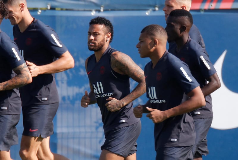 Neymar with Kylian Mbappe and teammates during training. Reuters