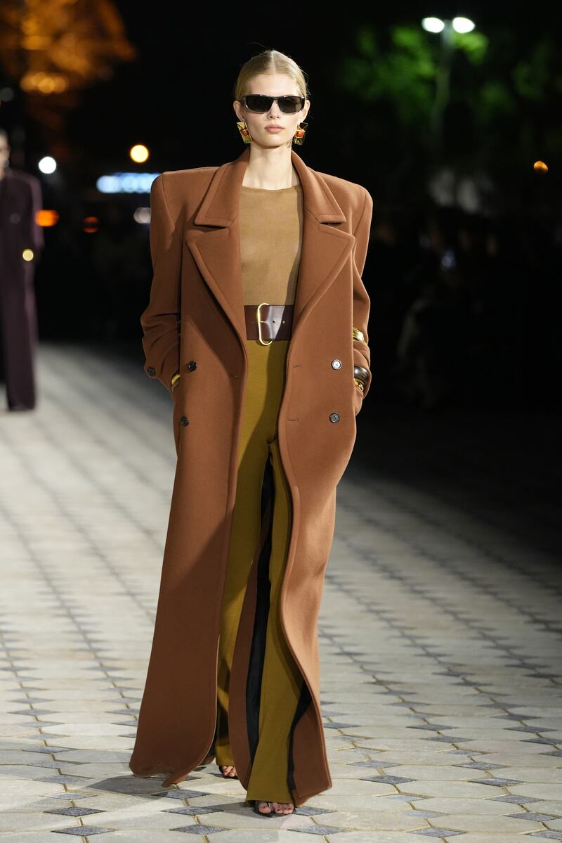 A simple dress is teamed with a coat with exaggerated shoulders. Getty Images