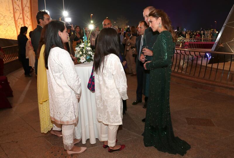 Britain's Prince William and Catherine, Duchess of Cambridge, speak with guests as they attend a reception hosted by the British High Commissioner to Pakistan, Thomas Drew, at the Pakistan National Monument in Islamabad, Pakistan. REUTERS