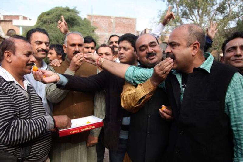 India's opposition Bharatiya Janata Party activists distribute sweets to celebrate the news of India executing Mohammed Ajmal Kasab, the lone surviving gunman from the 2008 terror attacks, in Jammu, India, Wednesday, Nov. 21, 2012. Kasab, a Pakistani citizen, was one of 10 gunmen who rampaged through the streets of India's financial capital for three days in November 2008, killing 166 people. (AP Photo/Channi Anand)