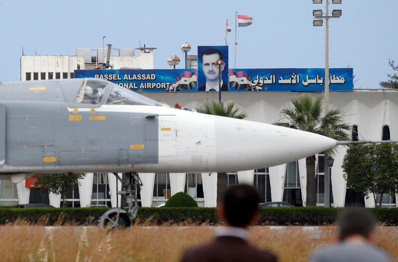 epa06382534 (FILE) - Russian Su-24 bomber passes by a portrait of Syrian President Bashar al-Assad at Hmeimym airbase in Latakia province , Syria, 04 May 2016 (reissued 11 December 2017). Media reports on 11 December 2017 state Russian President Vladimir Putin made an unannounced visit to Syria where he met with Syrian Presidents Bashar al-Assad and ordered a withdrawal of Russian troops from Syria.  EPA/SERGEI CHIRIKOV *** Local Caption *** 52738488