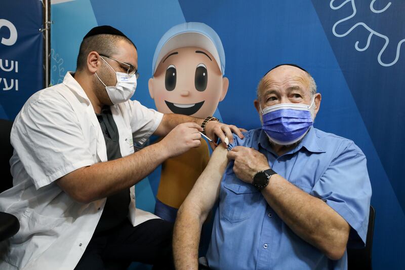 A man receives his third dose of the coronavirus vaccine at a Clalit healthcare centre in Jerusalem on August 11. Reuters