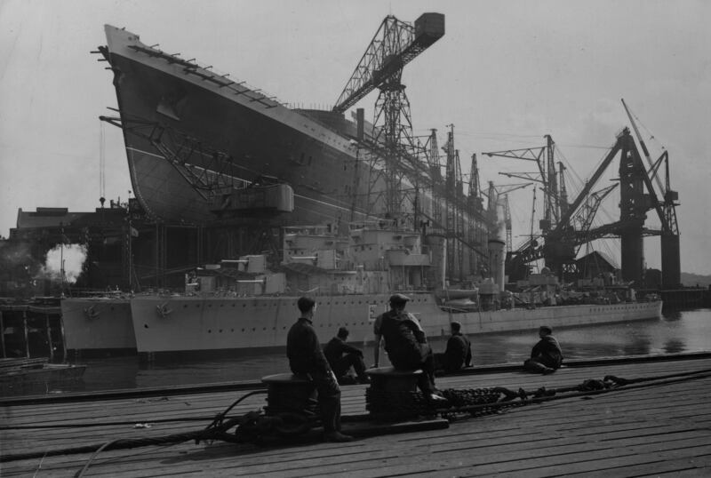 Workers at the John Brown shipyard in Clydebank, Glasgow, admire the Cunard White Star liner 'Queen Elizabeth' in 1938. Getty Images