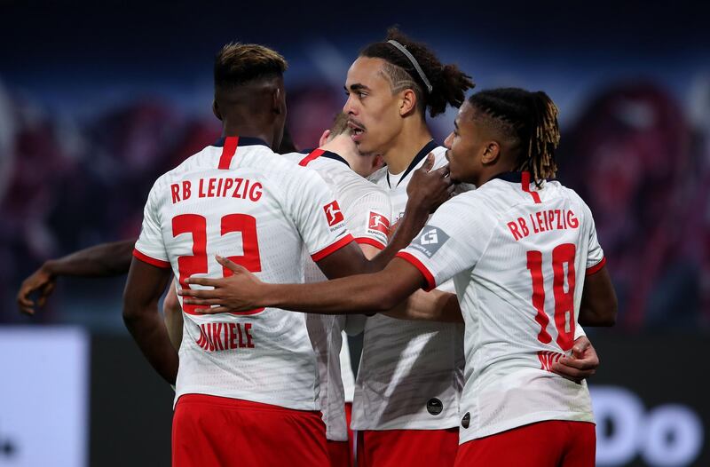 Leipzig's Danish forward Yussuf Poulsen (2nd R) celebrates scoring the 3-1 with his team-mates Leipzig's French midfielder Christopher Nkunku (R) and Leipzig's French defender Nordi Mukiele (L) during the German first division Bundesliga football match RB Leipzig v FC Augsburg in Leipzig, eastern Germany, on December 21, 2019. DFL REGULATIONS PROHIBIT ANY USE OF PHOTOGRAPHS AS IMAGE SEQUENCES AND/OR QUASI-VIDEO 
 / AFP / Ronny Hartmann / DFL REGULATIONS PROHIBIT ANY USE OF PHOTOGRAPHS AS IMAGE SEQUENCES AND/OR QUASI-VIDEO 
