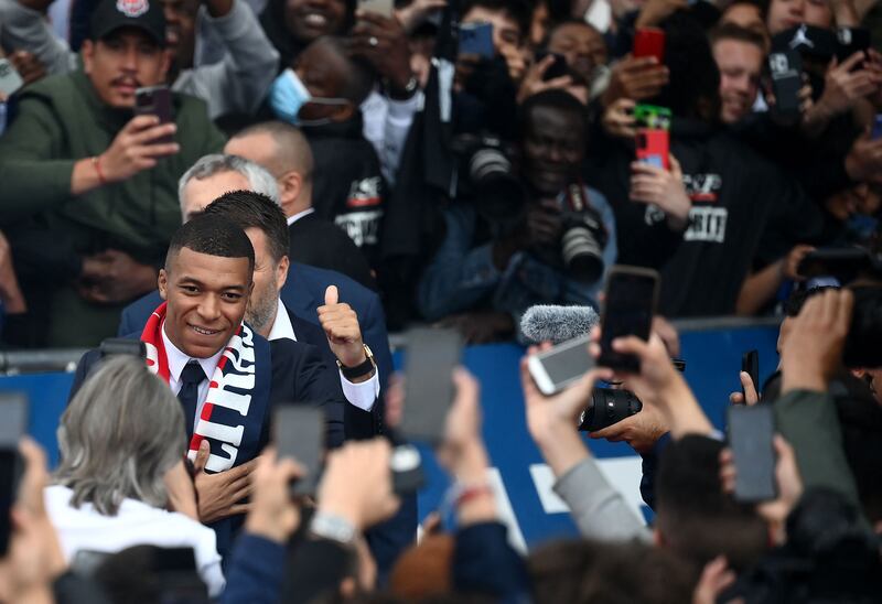 Kylian Mbappe is cheered by supporters outside the Parc des Princes. AFP