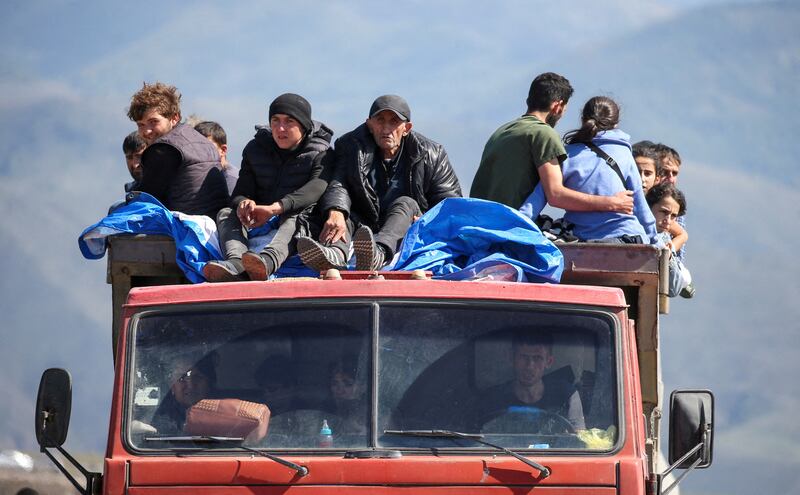 Refugees from the Nagorno-Karabakh region ride in a truck upon their arrival at the border village of Kornidzor in Armenia. Reuters