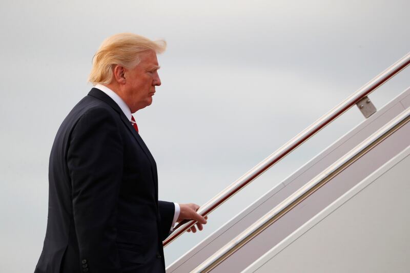 President Donald Trump boards Air Force One, Saturday, Oct. 7, 2017, in Andrews Air Force Base, Md., en route to a fundraiser in Greensboro, N.C.. (AP Photo/Carolyn Kaster)