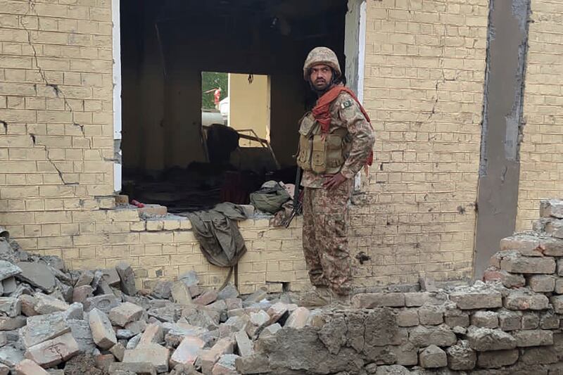 A soldier at the site of the suicide bombing that killed at least 26 security personnel in Dera Ismail Khan, Pakistan.