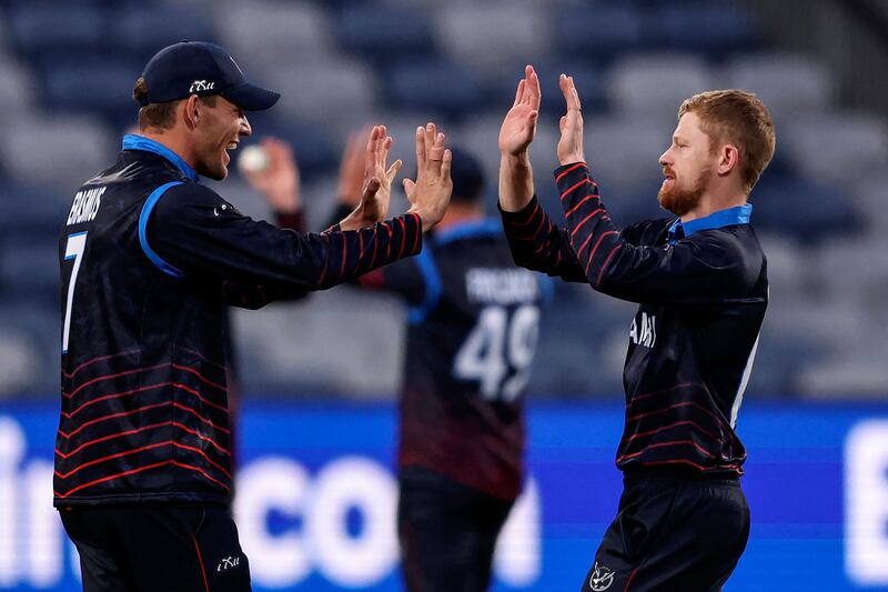 Namibia's Bernard Scholtz, right, celebrates with Gerhard Erasmus after taking the wicket of UAE's Vriitya Aravind for 21. AFP