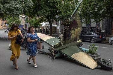 Women walk past the tail part of a Russian attack aircraft Su-25SM destroyed in fights with the Ukrainian army, displayed in downtown Kyiv, Ukraine, 09 August 2022.  Still being under the danger of shelling, with air sirens sounding from time to time, life in Ukraine's capital Kyiv is slowly returning to normal, after towns and villages in the northern part of the Kyiv region, became battlefields, heavily shelled, causing death and damage when Russian troops tried to reach Kyiv in February and March 2022.  Russian troops on 24 February entered Ukrainian territory, starting the conflict that has provoked destruction and a humanitarian crisis.   EPA / ROMAN PILIPEY