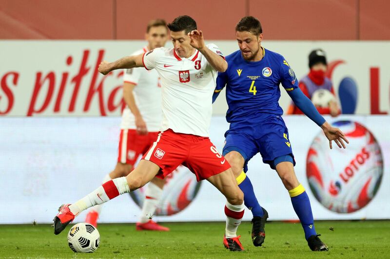 Poland's Robert Lewandowski under pressure from Marc Rebes of Andorra. EPA