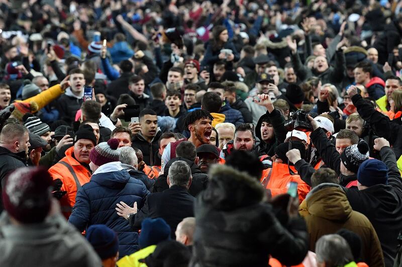 Aston Villa defender Tyrone Mings is mobbed by fans after their League Cup semi-final second-leg victory over Leicester City at Villa Park in Birmingham, on Tuesday, January 28. AFP