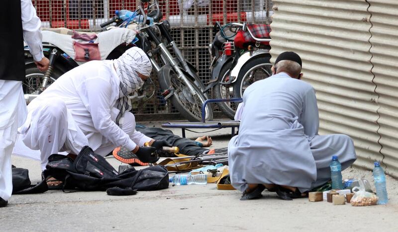 epa08515324 Pakistani security officials inspect weapons and ammunition recovered at the scene of an attack by unknown gunmen at Karachi Stock Exchange in Karachi, Pakistan, 29 June 2020. At least four gunmen and two civilians were reportedly killed and security forces have cordoned off the area as fighting is currently ongoing.  EPA/REHAN KHAN