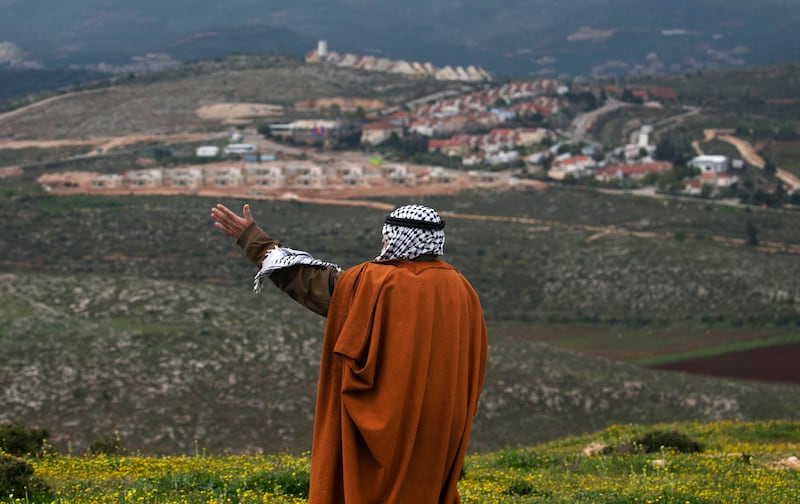 Abdallah Haj Mohamad, head of Jalud village's council, stands in front of the Jewish settlement of Shvut Rachel during a tour organised by Palestinian authorities to show the development of Israeli settlements in the occupied West Bank, on March 16, 2017.  All photos: AFP