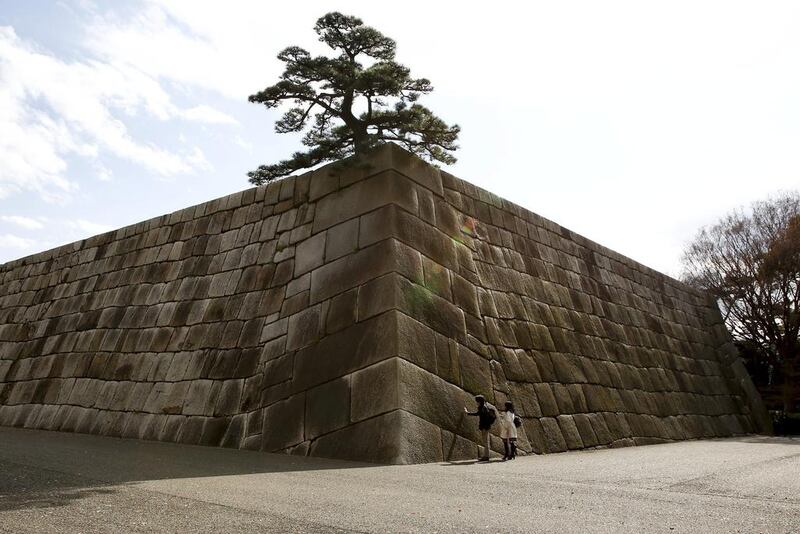 People look at the Tenshudai Donjon Base that was part of an Edo castle in the Imperial Palace compound in Tokyo, Japan. Thomas Peter / Reuters