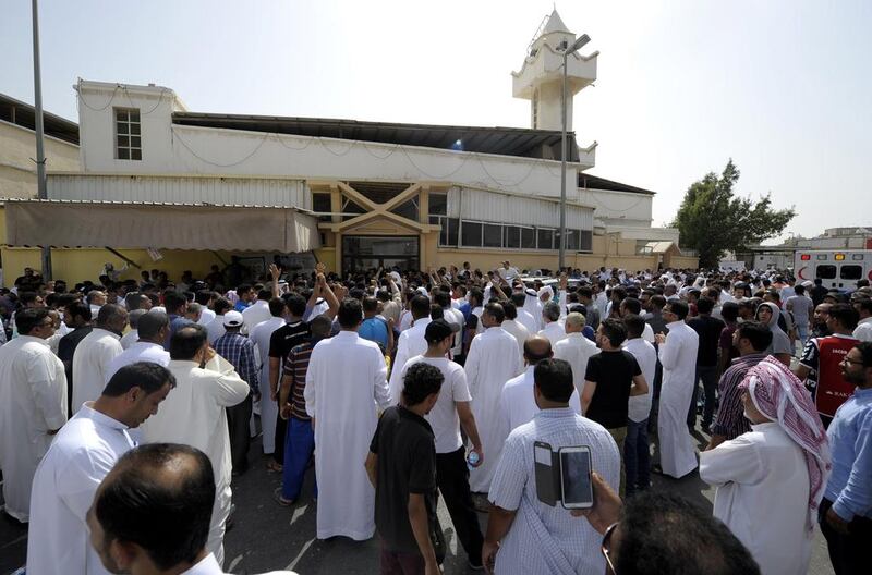 Saudi men gather outside the mosque. AFP Photo