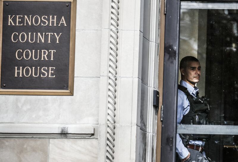 A law enforcement officer keeps watch at the the Kenosha County Courthouse as the jury deliberates for a third day. EPA