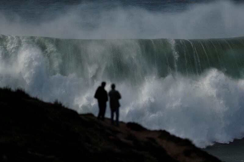 People gather to watch a tow-in surfing session at Praia do Norte in Nazare, Portugal. Rafael Marchante / Reuters