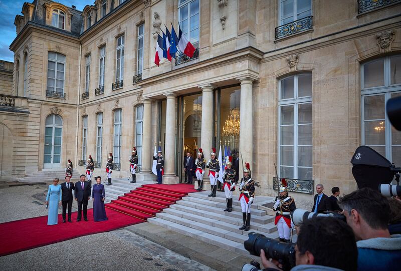 Mr Macron, Ms Macron, Mr Xi and Ms Peng at the steps of the Elysee Palace. Getty Images