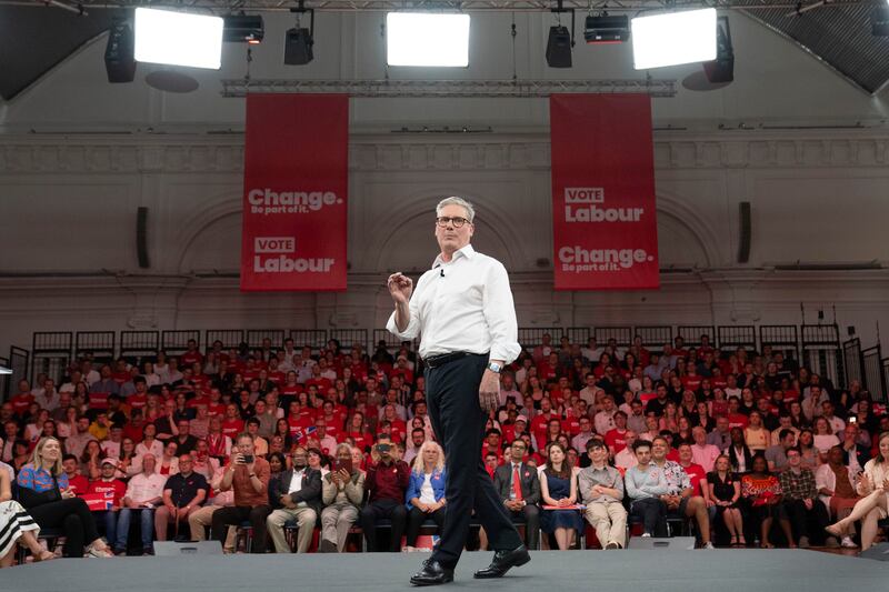 Mr Starmer addresses an audience of Labour Party members and supporters during a rally at the Royal Horticultural Halls in central London. AP