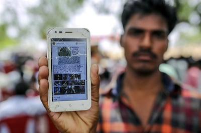 An attendee holds a mobile phone displaying a fake message shared on Facebook Inc.‚Äôs¬†WhatsApp¬†messaging service while attending an event to raise awareness on fake news in Balgera village in the district of Gadwal, Telangana, India, on Tuesday, June 12, 2018. At a time when governments around the world are grappling with fake news, police superintendent Rema¬†Rajeshwari's education campaign¬†to stop the spread of bogus social media messages in her district seems to be working. There's been no fake news-related deaths in more than 400 villages under her control in the southern state of Telangana. Photographer: Dhiraj Singh/Bloomberg