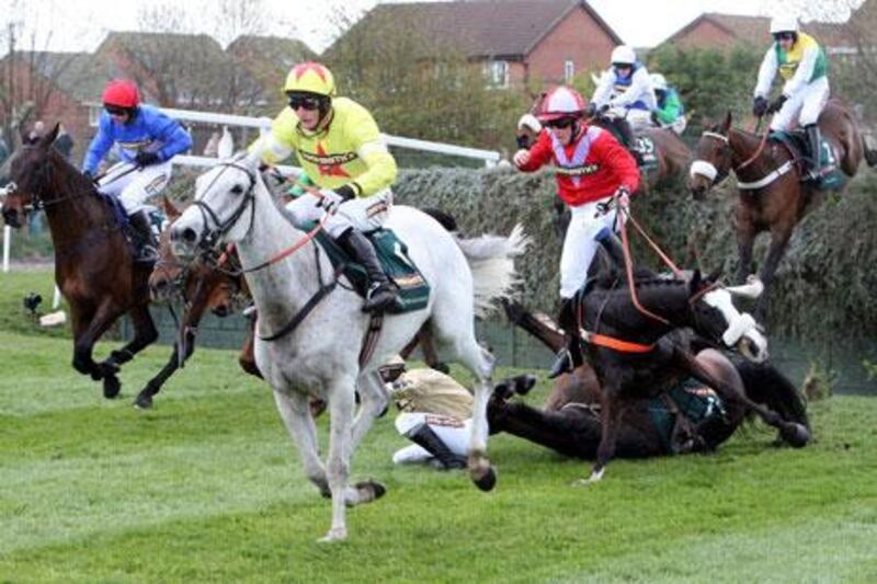 Neptune Collonges, ridden by Daryl Jacob, centre, passes Becher's Brook and goes on to win the Grand National at Aintree Racecourse. Scott Heppell / AP Photo