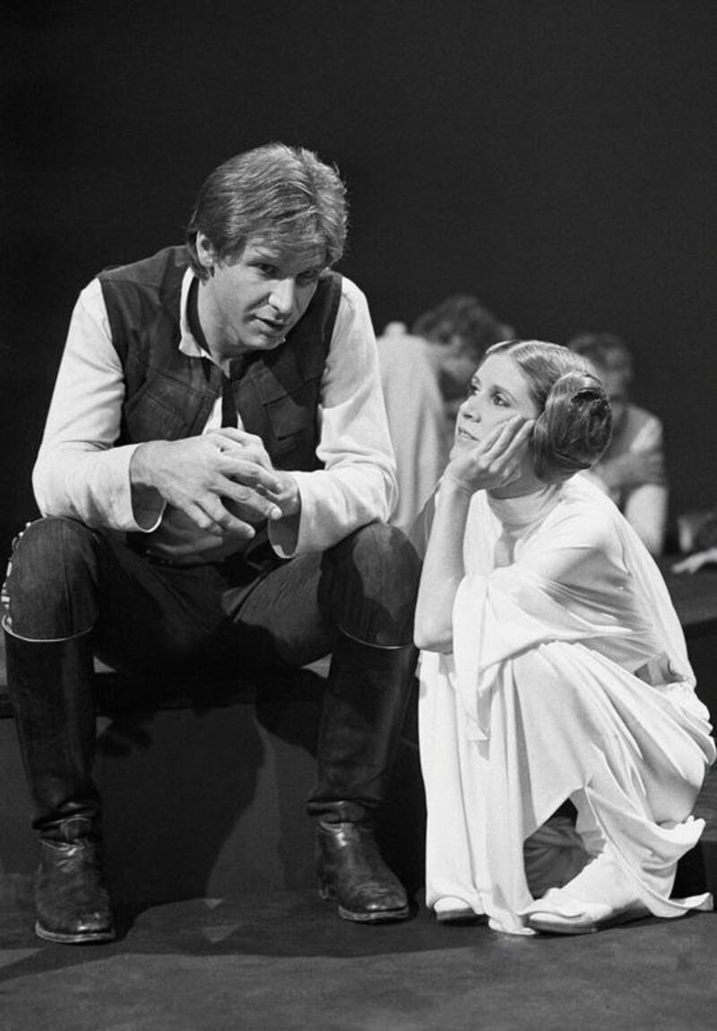 In this November 13, 1978 file photo, Harrison Ford talks with Carrie Fisher during a break in the filming of the CBS-TV special The Star Wars Holiday in Los Angeles. A publicist says Fisher has died at the age of 60. George Brich, File / AP photo