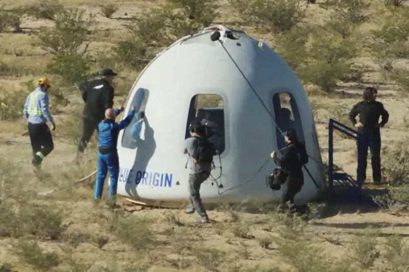 Billionaire Jeff Bezos gives a thumbs-up outside the capsule of Blue Origin’s New Shepard mission NS-18 after it landed by parachute near Van Horn, Texas.  Reuters