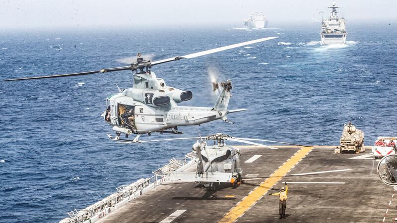 REFILE - REMOVING AND ADDING INFORMATION A U.S. Marines UH-1Y Venom helicopter takes off from the flight deck of the U.S. Navy amphibious assault ship USS Boxer, near a Light Marine Air Defense Integrated System (LMADIS) counter-unmanned aircraft system mounted on a vehicle parked at the bow, during its transit through Strait of Hormuz in Gulf of Oman, Arabian Sea, July 18, 2019. Picture taken July 18, 2019. Dalton Swanbeck/U.S. Navy/Handout via REUTERS ATTENTION EDITORS- THIS IMAGE HAS BEEN SUPPLIED BY A THIRD PARTY.