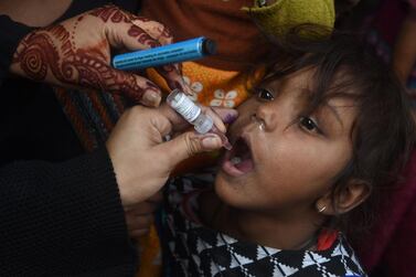 A Pakistani health worker administers polio vaccine drops to a child during a polio vaccination campaign in Lahore. AFP