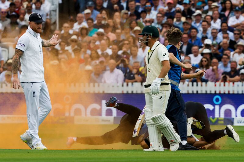 Just Stop Oil protester get stopped by security during the second Ashes Test at Lord's. AFP
