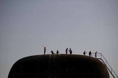 Demonstrators on the roof of The Egg, an abandoned cinema building in Beirut that is now showing films once again. Reuters