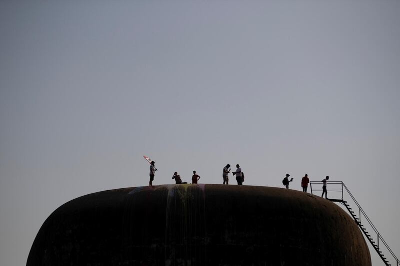 Demonstrators stand on the rooftop of the "Egg", an abandoned cinema building in Beirut, Lebanon, October 22, 2019. REUTERS/Alkis Konstantinidis     SEARCH "LEBANON EGG" FOR THIS STORY. SEARCH "WIDER IMAGE" FOR ALL STORIES