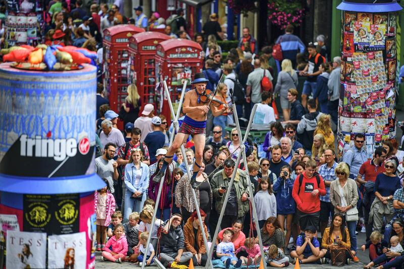 EDINBURGH, SCOTLAND - AUGUST 05: Edinburgh Festival Fringe entertainers perform on the Royal Mile on August 5, 2019 in Edinburgh, Scotland. The festival takes place in the Scottish capital from 2 to 26 August, and is marking its 72nd anniversary, this year sees some 3,841 shows performed in the world‚Äôs oldest fringe festival, that runs alongside the Edinburgh International Festival. (Photo by Jeff J Mitchell/Getty Images)