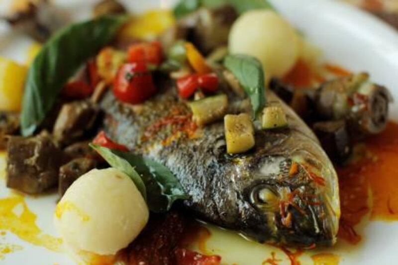 ABU DHABI, UNITED ARAB EMIRATES - July 9, 2009: The corniche Sheraton Hotel Executive Chef Fabien Martinez's  Seabream fish with Safron at La Mamma Restaurant in the Sheraton Hotel, Abu Dhabi.
( Ryan Carter / The National ) *** Local Caption ***  RC012-ChefMartinez.JPG